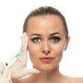 Cosmetic injection to the pretty Beautiful woman face and beautician hands with syringe.