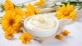 Cosmetic jar of body care cream with extract of Calendula on a light background Royalty Free Stock Photo