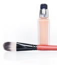 Cosmetic liquid foundation and brush on white