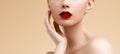 Cosmetic and Makeup. Beauty Fashion Model Woman face. Portrait with perfect skin. Red Lips and Nails Royalty Free Stock Photo