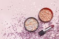 Cosmetic makeup blush, powder and red lipstick, holographic glitter confetti in the form of stars on pink background Flat lay top Royalty Free Stock Photo