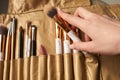 Cosmetic Makeup Brush in female hand on recruitment background.