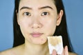 Cosmetic makeup remover, Asian woman cleaning face with cotton pad. Royalty Free Stock Photo