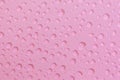 Cosmetic moisturizing liquid water drops on light red pink background. Toner or cleanser lotion