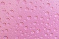 Cosmetic moisturizing liquid water drops on light red pink background. Toner or cleanser lotion