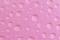 Cosmetic moisturizing liquid water drops on light red pink background. Toner or cleanser lotion