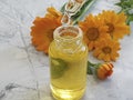 Cosmetic oil flower calendula accessories aromatherapy on concrete background Royalty Free Stock Photo