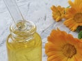 Cosmetic oil flower calendula aromatherapy on concrete background Royalty Free Stock Photo