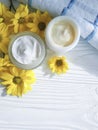 Cosmetic cream organic morning a jar yellow chrysanthemum flower white wooden, daisy, towel Royalty Free Stock Photo