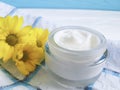 Cosmetic cream organic morning skincare ointment yellow chrysanthemum flower white wooden, daisy, towel Royalty Free Stock Photo