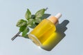 Cosmetic pipette with vitamin C. Transparent oil close-up. serum unbranded package. A sample of a cosmetic product. Blue