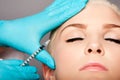 Cosmetic plastic surgeon injecting aesthetics face