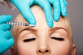 Cosmetic plastic surgeon injecting aesthetics face