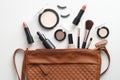 Cosmetic pouch with professional decorative cosmetics and makeup tools on white background. Top view, flat lay. Beauty and fashion Royalty Free Stock Photo