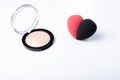 cosmetic powder on the white background and sponge