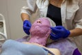 Cosmetic procedure. Woman in beauty salon with mask on her face. Face mask application. A woman makes an alginate mask Royalty Free Stock Photo