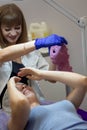 Cosmetic procedure. Woman in beauty salon with mask on her face. Face mask application. A woman makes an alginate mask Royalty Free Stock Photo