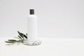 Cosmetic product mockup on white background. Plastic pump bottle for shampoo, lotion template. Stone terrazzo podium