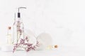 Cosmetic products and accessories for hygiene and skin cleansing with elegant lavender twig in soft light white interior on wood. Royalty Free Stock Photo