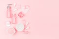 Cosmetic products and accessories in pink color - cream, bath salt, essential oil, soap, towel,  pearls, bottles, heart, bowl. Royalty Free Stock Photo