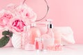 Cosmetic products for aromatherapy, spa salon - essential rose oil, bath salt, cream, soap, bath accessories with round mirror. Royalty Free Stock Photo