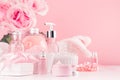 Cosmetic products for aromatherapy, spa salon - essential rose oil, bath salt, cream, soap, bath accessories and roses in pink. Royalty Free Stock Photo