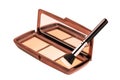 Cosmetic products isolated. Close-up of a elegant cosmetic multi-color box with mirror, eye shadows powder and a eye shadow brush