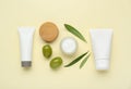 Cosmetic products with olive essential oil on beige background, flat lay Royalty Free Stock Photo