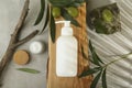 Cosmetic products with olive essential oil on light grey table, flat lay Royalty Free Stock Photo