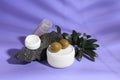 Cosmetic products and olives on lilac background Royalty Free Stock Photo