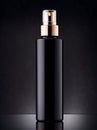 Mockup of black cosmetic bottle on black background