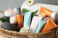 Cosmetic products and towels in wicker tray, closeup Royalty Free Stock Photo