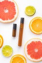 Cosmetic roller oil and citrus fruits . Cosmetic procedures. Healthy skin. Skin care. Citrus oil. White background. Copy Royalty Free Stock Photo