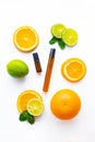 Cosmetic roller oil and citrus fruits . Cosmetic procedures. Healthy skin. Skin care. Citrus oil. White background. Copy Royalty Free Stock Photo