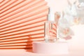 Cosmetic serum with peptides product presentation mockup on podium pedestal and chinese paper fan pink floral background Royalty Free Stock Photo
