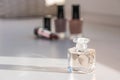Cosmetic set. Nail polish, lipsticks and perfume. Selective focus on front bottle.Bottle of woman perfume.Still life Royalty Free Stock Photo