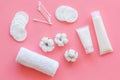 Hygiene cotton swabs, pads and cream for pattern on pink background top view Royalty Free Stock Photo