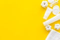 Hygiene cotton swabs, pads and cream for pattern on yellow background top view mock up Royalty Free Stock Photo