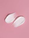 Cosmetic smear, cream texture on a pink background. Skin care