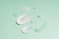 cosmetic smears cream texture on green background. Beauty serum drop. Transparent and creamy skin care product sample..