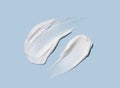 Cosmetic smears of cream texture on pastel blue background. Skin hydration Royalty Free Stock Photo