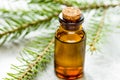 Cosmetic spruce oil in bottles with fur branches on white table background Royalty Free Stock Photo