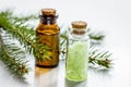 Cosmetic spruce oil and salt in bottles with fur branches on white table background Royalty Free Stock Photo