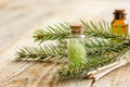 Cosmetic spruce oil and salt in bottles with fur branches on wooden table background Royalty Free Stock Photo