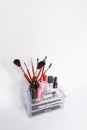 Cosmetic storage with cosmetics brushes and lipsticks Royalty Free Stock Photo