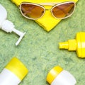 Cosmetic sunscreen products with towel and sunglasses Royalty Free Stock Photo