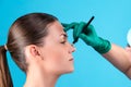 Cosmetic surgeon examining female client in office. Doctor draws lines with a marker, the eyelid before plastic surgery Royalty Free Stock Photo