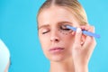 Cosmetic surgeon examining female client in office. Doctor draws lines with a marker, the eyelid before plastic surgery Royalty Free Stock Photo