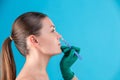 Cosmetic surgeon examining female client in office. Doctor checking woman`s face, the nose before plastic surgery Royalty Free Stock Photo