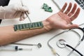 The cosmetic surgeon made a small incision to insert the chip into the patient& x27;s arm. Biotechnology, electronic